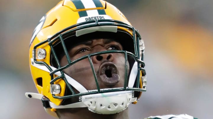 Green Bay Packers defensive tackle Jarran Reed (90) celebrates his sack of New England Patriots quarterback Bailey Zappe.