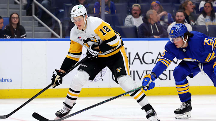 Sep 21, 2024; Buffalo, New York, USA;  Pittsburgh Penguins right wing Jesse Puljujarvi (18) looks to take a shot on goal as Buffalo Sabres defenseman Owen Power (25) defends during the third period at KeyBank Center.