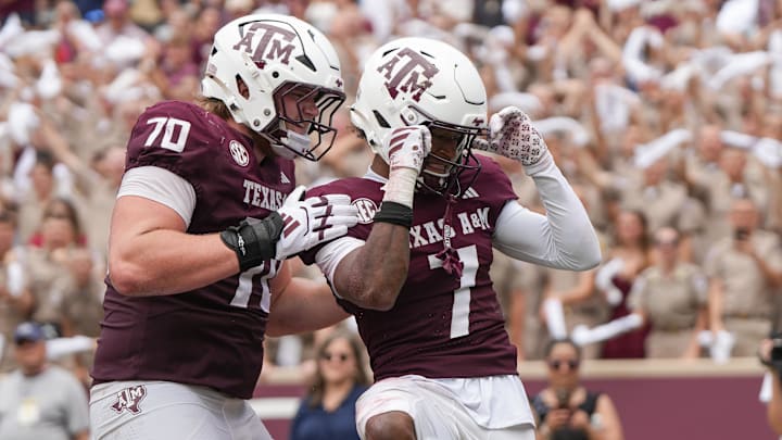 Texas A&M Aggies offensive lineman Robert Bourdon (70) and wide receiver KC Concepcion (7) celebrate after a touchdown during the second half against the Utah State Aggies at Kyle Field.