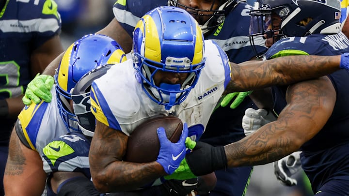 Nov 3, 2024; Seattle, Washington, USA; Los Angeles Rams running back Kyren Williams (23) rushes against Seattle Seahawks defensive tackle Byron Murphy II (91) and defensive tackle Johnathan Hankins (97) during the third quarter at Lumen Field. Mandatory Credit: Joe Nicholson-Imagn Images Nov 3, 2024; Seattle, Washington, USA; Los Angeles Rams running back Kyren Williams (23) rushes against Seattle Seahawks defensive tackle Byron Murphy II (91) and defensive tackle Johnathan Hankins (97) during the third quarter at Lumen Field. Mandatory Credit: Joe Nicholson-Imagn Images