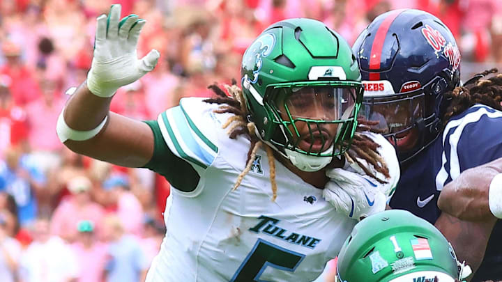 Sep 20, 2025; Oxford, Mississippi, USA; Mississippi Rebels running back Kewan Lacy (5) runs the ball as Tulane Green Wave defensive end Harvey Dyson (5) and Tulane Green Wave defensive back Jack Tchienchou (1) attempt to make the tackle during the first quarter at Vaught-Hemingway Stadium. Mandatory Credit: Petre Thomas-Imagn Images Sep 20, 2025; Oxford, Mississippi, USA; Mississippi Rebels running back Kewan Lacy (5) runs the ball as Tulane Green Wave defensive end Harvey Dyson (5) and Tulane Green Wave defensive back Jack Tchienchou (1) attempt to make the tackle during the first quarter at Vaught-Hemingway Stadium. Mandatory Credit: Petre Thomas-Imagn Images