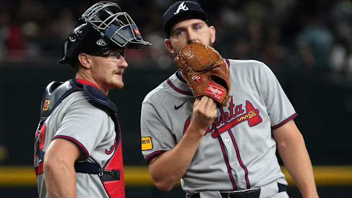 Atlanta Braves catcher Sean Murphy (12) and pitcher Dylan Lee (52) talk in the eighth inning against the Arizona Diamondbacks at Chase Field.