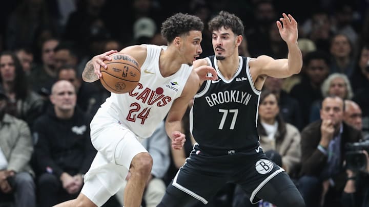  Oct 24, 2025; Brooklyn, New York, USA;  Cleveland Cavaliers guard Tyrese Proctor (24) looks to drive past Brooklyn Nets guard Ben Saraf (77) in the first quarter at Barclays Center. Mandatory Credit: Wendell Cruz-Imagn Images