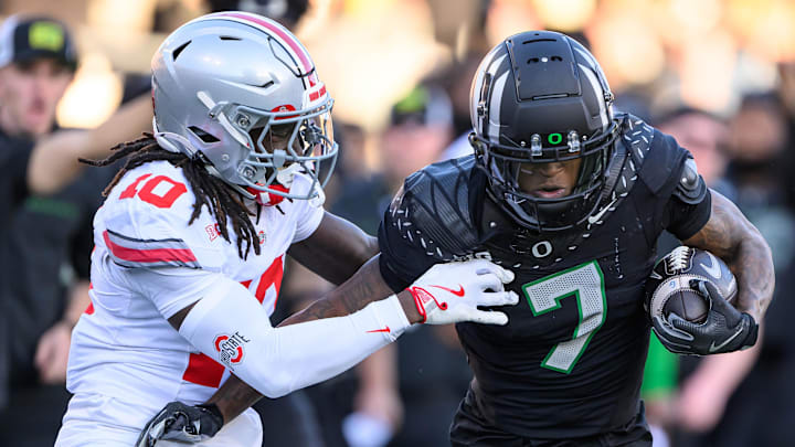 Oct 12, 2024; Eugene, Oregon, USA; Oregon Ducks wide receiver Evan Stewart (7) fights for yards after a catch against the tackle of Ohio State Buckeyes cornerback Denzel Burke (10) during the second quarterat Autzen Stadium. Mandatory Credit: Craig Strobeck-Imagn Images Oct 12, 2024; Eugene, Oregon, USA; Oregon Ducks wide receiver Evan Stewart (7) fights for yards after a catch against the tackle of Ohio State Buckeyes cornerback Denzel Burke (10) during the second quarterat Autzen Stadium. Mandatory Credit: Craig Strobeck-Imagn Images