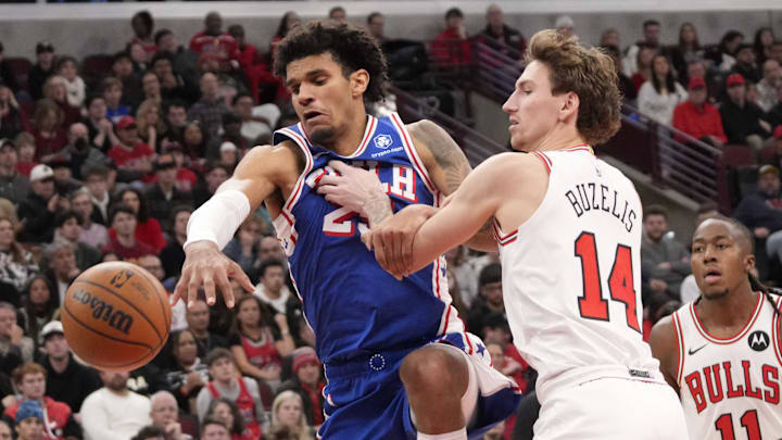 Dec 26, 2025; Chicago, Illinois, USA; Chicago Bulls forward Matas Buzelis (14) defends Philadelphia 76ers forward Dominick Barlow (25) during the second half at United Center. Mandatory Credit: David Banks-Imagn Images