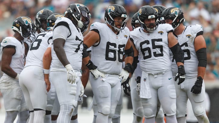 Sep 15, 2024; Jacksonville, Florida, USA;  Jacksonville Jaguars offensive line Anton Harrison (77), offensive line Brandon Scherff (68), and offensive line Mitch Morse (65) wait to line up for the drive against the Cleveland Browns during the third quarter at EverBank Stadium. Mandatory Credit: Morgan Tencza-Imagn Images