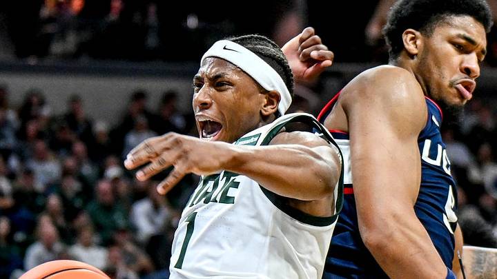 Michigan State’s Jeremy Fears Jr., left, celebrates after dunking as UConn’s Na’jai Hines, right, defends during the first half on Tuesday, Oct. 20, 2026, at the Breslin Center in East Lansing.
