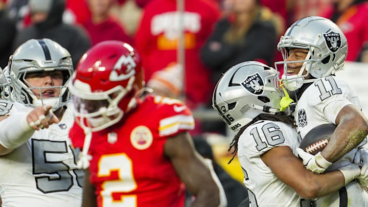 Nov 29, 2024; Kansas City, Missouri, USA; Las Vegas Raiders wide receiver Tre Tucker (11) celebrates with wide receiver Jakobi Meyers (16) after scoring a touchdown during the second half against the Kansas City Chiefs at GEHA Field at Arrowhead Stadium. Mandatory Credit: Jay Biggerstaff-Imagn Images