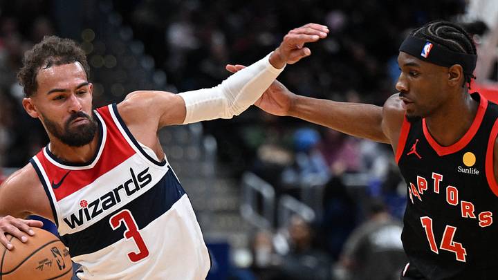 Washington Wizards guard Trae Young dribbles as Toronto Raptors guard Ja'kobe Walter defends. Washington Wizards guard Trae Young dribbles as Toronto Raptors guard Ja'kobe Walter defends.