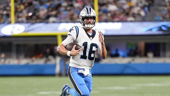 Aug 21, 2025; Charlotte, North Carolina, USA;  Carolina Panthers quarterback Jack Plummer (16) keeps the ball for a gain chased by Pittsburgh Steelers cornerback James Pierre (42) and cornerback Brandin Echols (26) during the second quarter at Bank of America Stadium. Mandatory Credit: Jim Dedmon-Imagn Images