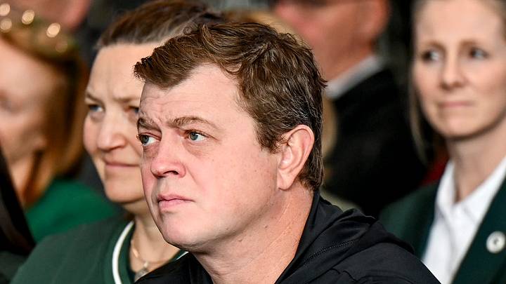 Michigan State hockey coach Adam Nightingale listens during new football coach Pat Fitzgerald's introductory press conference on Tuesday, Dec. 2, 2025, at the Tom Izzo Football Building in East Lansing.