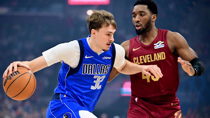 Mar 15, 2026; Cleveland, Ohio, USA; Dallas Mavericks forward Cooper Flagg (32) drives to the basket against Cleveland Cavaliers guard Donovan Mitchell (45) during the first quarter at Rocket Arena. Mandatory Credit: Ken Blaze-Imagn Images