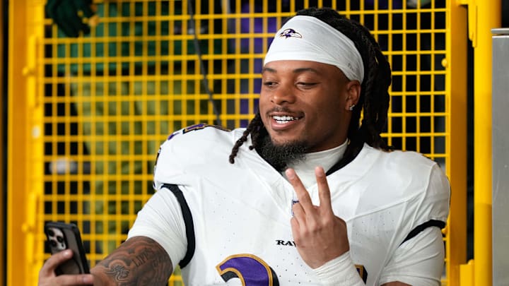 Keaton Mitchell takes a pregame selfie with fans.