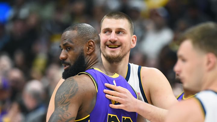 Feb 22, 2025; Denver, Colorado, USA; Denver Nuggets center Nikola Jokic (15) and Los Angeles Lakers forward LeBron James (23) hug before the game at Ball Arena.