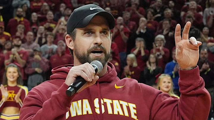Iowa State football coach Jimmy Rogers speaks during a timeout in the Cy-Hawk men's basketball game on Dec. 11, 2025, at Hilton Coliseum in Ames. Iowa State football coach Jimmy Rogers speaks during a timeout in the Cy-Hawk men's basketball game on Dec. 11, 2025, at Hilton Coliseum in Ames.
