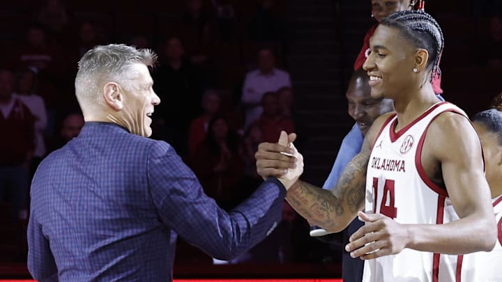 Oklahoma forward Jalon Moore and head coach Porter Moser Oklahoma forward Jalon Moore and head coach Porter Moser