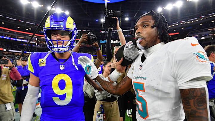 Los Angeles Rams quarterback Matthew Stafford (9) meets with Miami Dolphins cornerback Jalen Ramsey (5) 