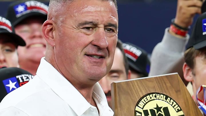 Celina head football coach and athletic director Bill Elliott holds the UIL state 4A Division I state championship trophy following his team's victory over Kilgore in the 2024 title game at AT&T Stadium.