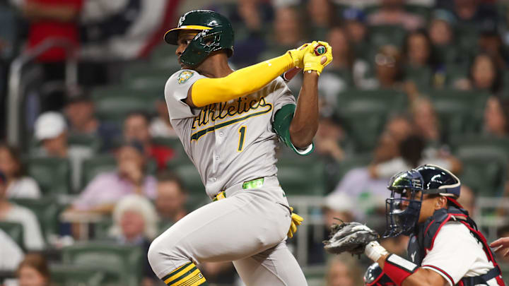 Mar 31, 2026; Atlanta, Georgia, USA; Athletics center fielder Denzel Clarke (1) hits a single against the Atlanta Braves in the seventh inning at Truist Park. Mandatory Credit: Brett Davis-Imagn Images