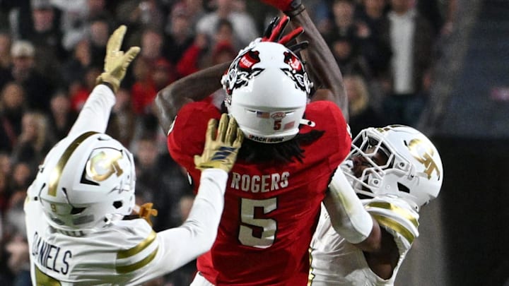 Nov 1, 2025; Raleigh, North Carolina, USA;  North Carolina State Wolfpack wide receiver Noah Rogers attempts to catch the ball against Georgia Tech Yellow Jackets defensive back Omar Daniels (9) during the second quarter at Carter-Finley Stadium. Mandatory Credit: Zachary Taft-Imagn Images