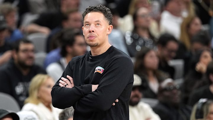 Feb 4, 2026; San Antonio, Texas, USA; San Antonio Spurs coach Mitch Johnson looks at the scoreboard during the second half against the Oklahoma City Thunder at Frost Bank Center.
