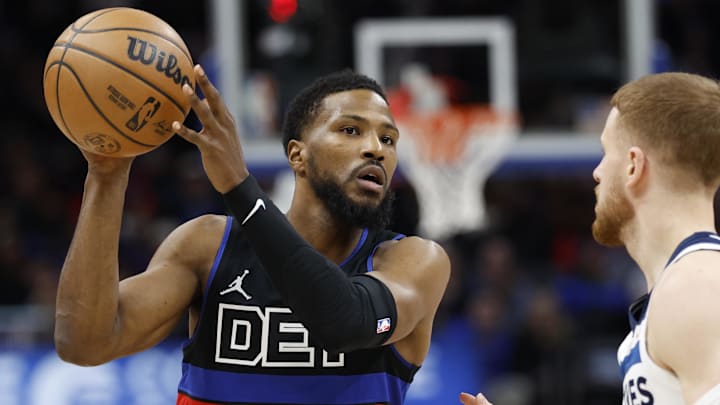 Jan 4, 2025; Detroit, Michigan, USA;  Detroit Pistons guard Malik Beasley (5) is defended by Minnesota Timberwolves guard Donte DiVincenzo (0) in the first half at Little Caesars Arena. Mandatory Credit: Rick Osentoski-Imagn Images