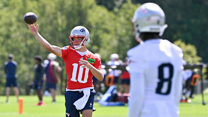 Jul 23, 2025; Foxborough, MA, USA; New England Patriots quarterback Drake Maye (10) throws a pass to wide receiver Stefon Diggs (8) during training camp at Gillette Stadium. Mandatory Credit: Eric Canha-Imagn Images