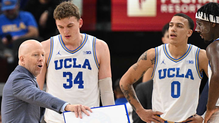 Dec 28, 2024; Inglewood, California, USA; UCLA Bruins head coach Mick Cronin talks to UCLA Bruins forward Tyler Bilodeau (34) and guard Kobe Johnson (0) during the second half against the Gonzaga Bulldogs at Intuit Dome. Mandatory Credit: Robert Hanashiro-Imagn Images Dec 28, 2024; Inglewood, California, USA; UCLA Bruins head coach Mick Cronin talks to UCLA Bruins forward Tyler Bilodeau (34) and guard Kobe Johnson (0) during the second half against the Gonzaga Bulldogs at Intuit Dome. Mandatory Credit: Robert Hanashiro-Imagn Images