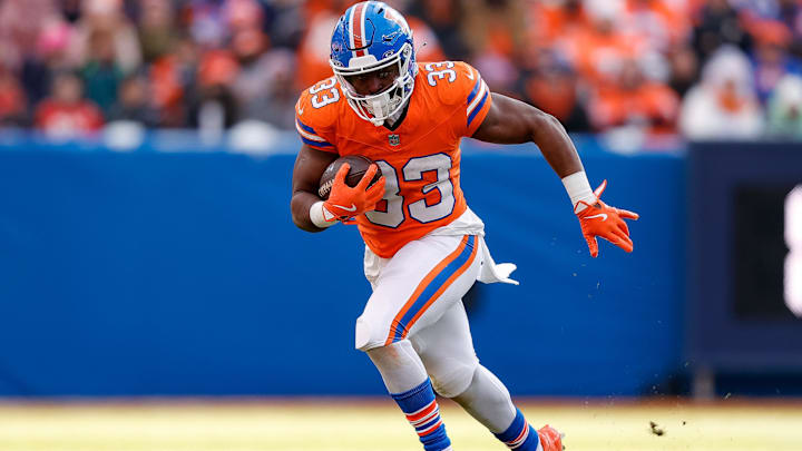 Jan 5, 2025; Denver, Colorado, USA; Denver Broncos running back Javonte Williams (33) runs the ball in the second quarter against the Kansas City Chiefs at Empower Field at Mile High. 