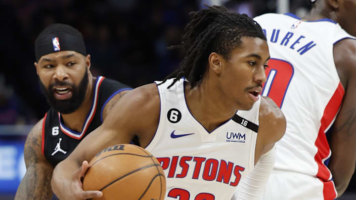 Dec 26, 2022; Detroit, Michigan, USA;  Detroit Pistons guard Jaden Ivey (23) dribbles on LA Clippers forward Marcus Morris Sr. (8) in the first half at Little Caesars Arena. Mandatory Credit: Rick Osentoski-Imagn Images