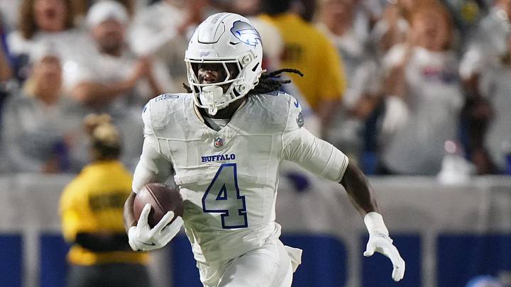 Oct 5, 2025; Orchard Park, New York, USA; Buffalo Bills running back James Cook (4) rushes the ball against the New England Patriots during the first half at Highmark Stadium. Mandatory Credit: Gregory Fisher-Imagn Images