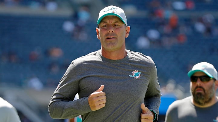 Aug 14, 2021; Chicago, Illinois, USA; Miami Dolphins assistant head coach and special teams coordinator Danny Crossman runs off the field after warmups before the game against the Chicago Bears at Soldier Field. Mandatory Credit: Jon Durr-Imagn Images