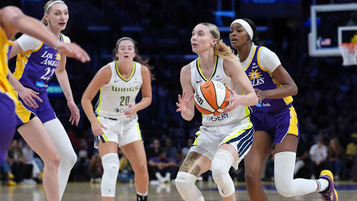 Aug 20, 2025; Los Angeles, California, USA; Dallas Wings guard Paige Bueckers (5) is defended by LA Sparks forward Cameron Brink (22) and forward Rickea Jackson (2) in the first half at Crypto.com Arena. Mandatory Credit: Kirby Lee-Imagn Images