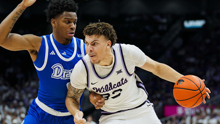 Dec 17, 2024; Kansas City, Missouri, USA; Kansas State Wildcats guard Coleman Hawkins (33) drives against Drake Bulldogs guard Tavion Banks (6) during the first half at T-Mobile Center. Mandatory Credit: Jay Biggerstaff-Imagn Images Dec 17, 2024; Kansas City, Missouri, USA; Kansas State Wildcats guard Coleman Hawkins (33) drives against Drake Bulldogs guard Tavion Banks (6) during the first half at T-Mobile Center. Mandatory Credit: Jay Biggerstaff-Imagn Images