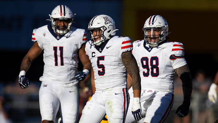 Nov 25, 2023; Tempe, Arizona, USA; Arizona Wildcats linebacker Jacob Manu (5) with edge Taylor Upshaw (11) and defensive lineman Tiaoalii Savea (98) against the Arizona State Sun Devils during the Territorial Cup at Mountain America Stadium. Mandatory Credit: Mark J. Rebilas-USA TODAY Sports