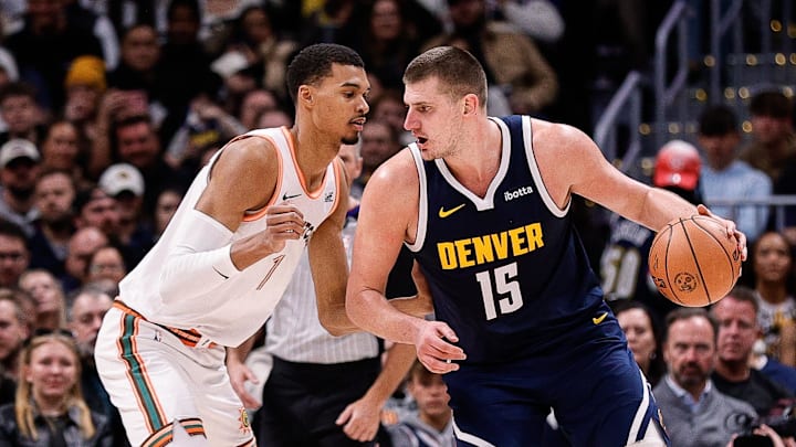 Nov 26, 2023; Denver, Colorado, USA; Denver Nuggets center Nikola Jokic (15) controls the ball as San Antonio Spurs center Victor Wembanyama (1) guards in the third quarter at Ball Arena. Nov 26, 2023; Denver, Colorado, USA; Denver Nuggets center Nikola Jokic (15) controls the ball as San Antonio Spurs center Victor Wembanyama (1) guards in the third quarter at Ball Arena.