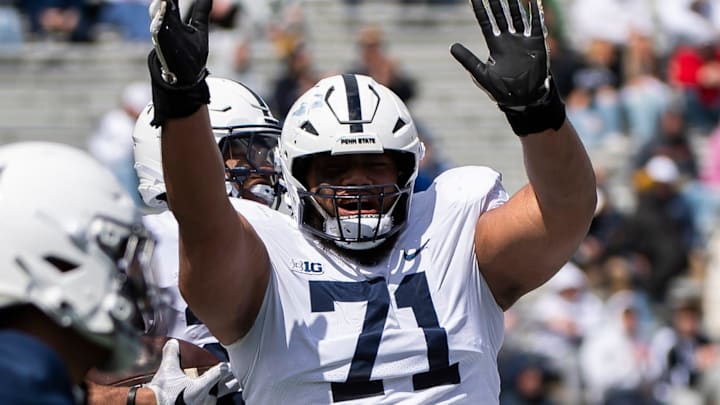 Penn State offensive lineman Vega Ioane (71) celebrates with running back Quinton Martin after the freshman scored a touchdown during the Blue-White game at Beaver Stadium on Saturday, April 13, 2024, in State College. The White team defeated the Blue team, 27-0.