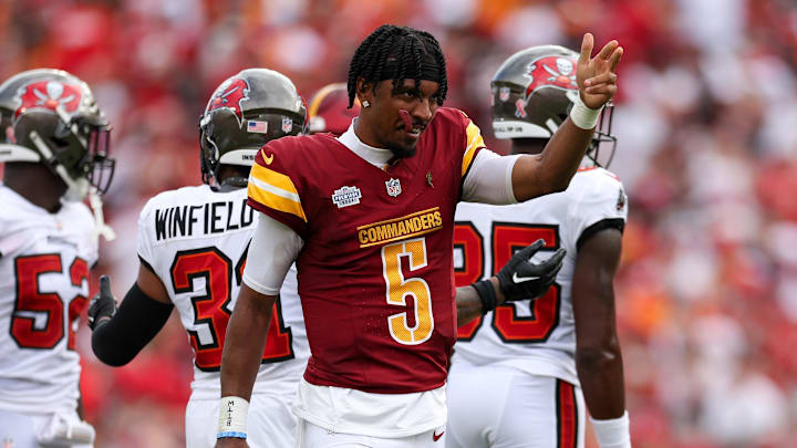 Sep 8, 2024; Tampa, Florida, USA; Washington Commanders quarterback Jayden Daniels (5) reacts after a first down against the Tampa Bay Buccaneers in the second quarter at Raymond James Stadium. Mandatory Credit: Nathan Ray Seebeck-Imagn Images