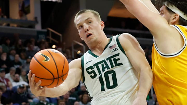 Michigan State's Denham Wojcik (10) drops off an assist from underneath the basket against the Toledo Rockets at the Breslin Center on Tuesday, Dec. 16, 2025. Michigan State's Denham Wojcik (10) drops off an assist from underneath the basket against the Toledo Rockets at the Breslin Center on Tuesday, Dec. 16, 2025.