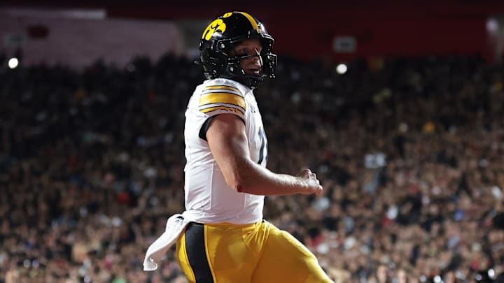 Sep 19, 2025; Piscataway, New Jersey, USA; Iowa Hawkeyes quarterback Mark Gronowski (11) scores a rushing touchdown during the first half against the Rutgers Scarlet Knights at SHI Stadium. Mandatory Credit: Vincent Carchietta-Imagn Images Sep 19, 2025; Piscataway, New Jersey, USA; Iowa Hawkeyes quarterback Mark Gronowski (11) scores a rushing touchdown during the first half against the Rutgers Scarlet Knights at SHI Stadium. Mandatory Credit: Vincent Carchietta-Imagn Images