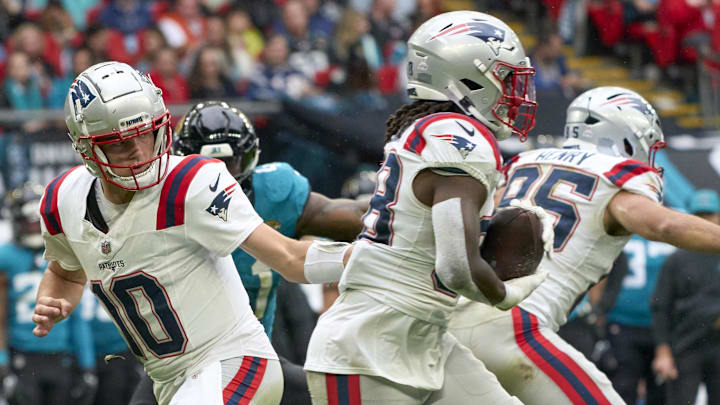 Oct 20, 2024; London, United Kingdom; New England Patriots quarterback Drake Maye (10) passes to New England Patriots running back Rhamondre Stevenson (38) in the first half during an NFL International Series game at Wembley Stadium. Mandatory Credit: Peter van den Berg-Imagn Images