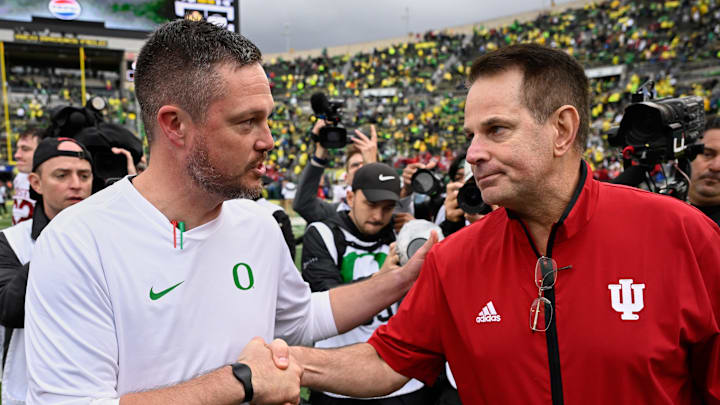 Oct 11, 2025; Eugene, Oregon, USA; Oregon Ducks head coach Dan Lanning shakes hands with Indiana Hoosiers head coach Curt Cignetti after Indiana defeated Oregon by the score of 30-20 at Autzen Stadium. Mandatory Credit: Troy Wayrynen-Imagn Images