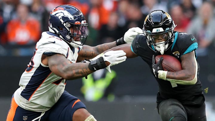 Oct 30, 2022; London, United Kingdom, Jacksonville Jaguars running back Travis Etienne Jr. (1) is chased down by Denver Broncos defensive end Dre'Mont Jones (93) in the fourth quarter during an NFL International Series game at Wembley Stadium. Mandatory Credit: Nathan Ray Seebeck-Imagn Images