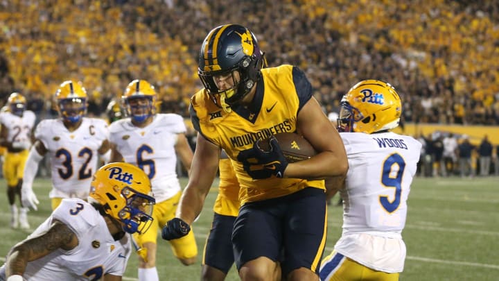 West Virginia Mountaineers Kole Taylor (87) leaps around Pittsburgh Panthers Donovan McMillon (3) for a touchdown during the first half at Milan Puskar Stadium in Morgantown, WV on September 16, 2023.