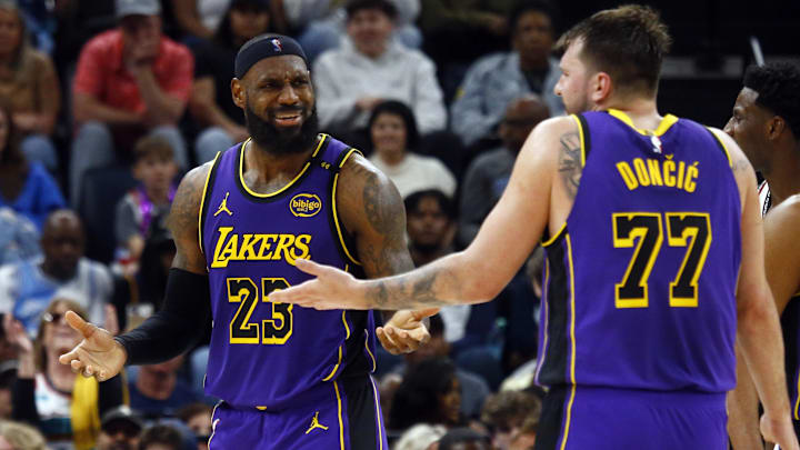 Mar 29, 2025; Memphis, Tennessee, USA; Los Angeles Lakers forward LeBron James (23) and guard Luka Doncic (77) react during the third quarter against the Memphis Grizzlies at FedExForum. Mandatory Credit: Petre Thomas-Imagn Images