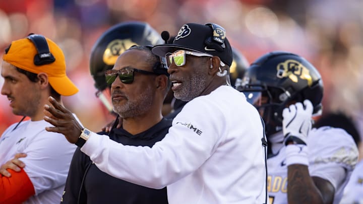 Oct 19, 2024; Tucson, Arizona, USA; Colorado Buffaloes head coach Deion Sanders (right) with wide receivers coach Jason Phillips against the Arizona Wildcats at Arizona Stadium. Mandatory Credit: Mark J. Rebilas-Imagn Images
