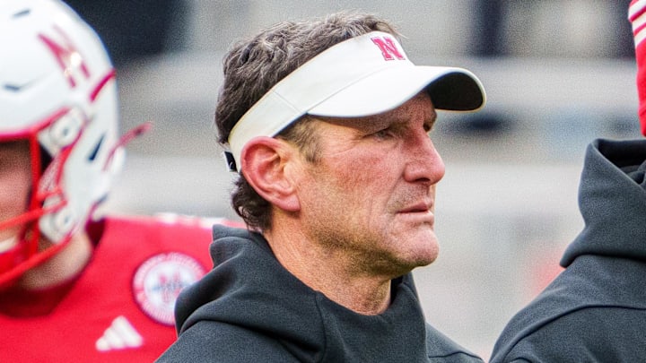 Nov 28, 2025; Lincoln, Nebraska, USA; Nebraska Cornhuskers assistant coach Mike Ekeler (left) watches warmups before the game against the Iowa Hawkeyes at Memorial Stadium. Mandatory Credit: Dylan Widger-Imagn Images