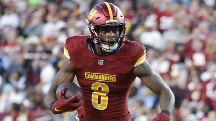 Oct 20, 2024; Landover, Maryland, USA; Washington Commanders running back Brian Robinson Jr. (8) carries the ball as Carolina Panthers cornerback Michael Jackson (2) and Panthers linebacker DJ Johnson (52) defends during the second half at Northwest Stadium. Mandatory Credit: Amber Searls-Imagn Images Oct 20, 2024; Landover, Maryland, USA; Washington Commanders running back Brian Robinson Jr. (8) carries the ball as Carolina Panthers cornerback Michael Jackson (2) and Panthers linebacker DJ Johnson (52) defends during the second half at Northwest Stadium. Mandatory Credit: Amber Searls-Imagn Images