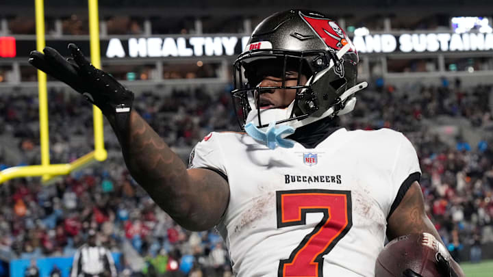 Dec 1, 2024; Charlotte, North Carolina, USA; Tampa Bay Buccaneers running back Bucky Irving (7) blows a kiss to the crowd after scoring a touchdown in the fourth quarter at Bank of America Stadium. Mandatory Credit: Bob Donnan-Imagn Images