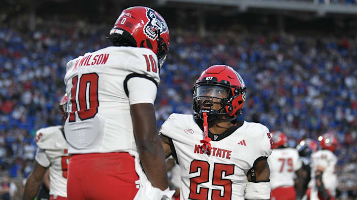 Sep 20, 2025; Durham, North Carolina, USA; North Carolina State Wolfpack Darius Johnson(25) celebrates North Carolina State Wolfpack quarterback Will Wilson's (10) touchdown in the fourth quarter against the Duke Blue Devils at Wallace Wade Stadium. Mandatory Credit: Zachary Taft-Imagn Images Sep 20, 2025; Durham, North Carolina, USA; North Carolina State Wolfpack Darius Johnson(25) celebrates North Carolina State Wolfpack quarterback Will Wilson's (10) touchdown in the fourth quarter against the Duke Blue Devils at Wallace Wade Stadium. Mandatory Credit: Zachary Taft-Imagn Images